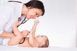 smiling doctor examining baby
