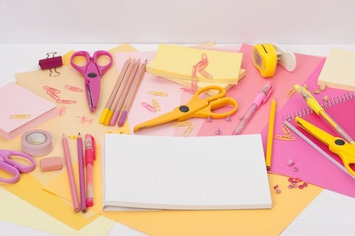 assorted stationery items laid out on a desk