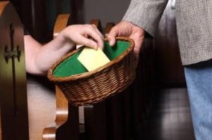 church offering envelope in basket